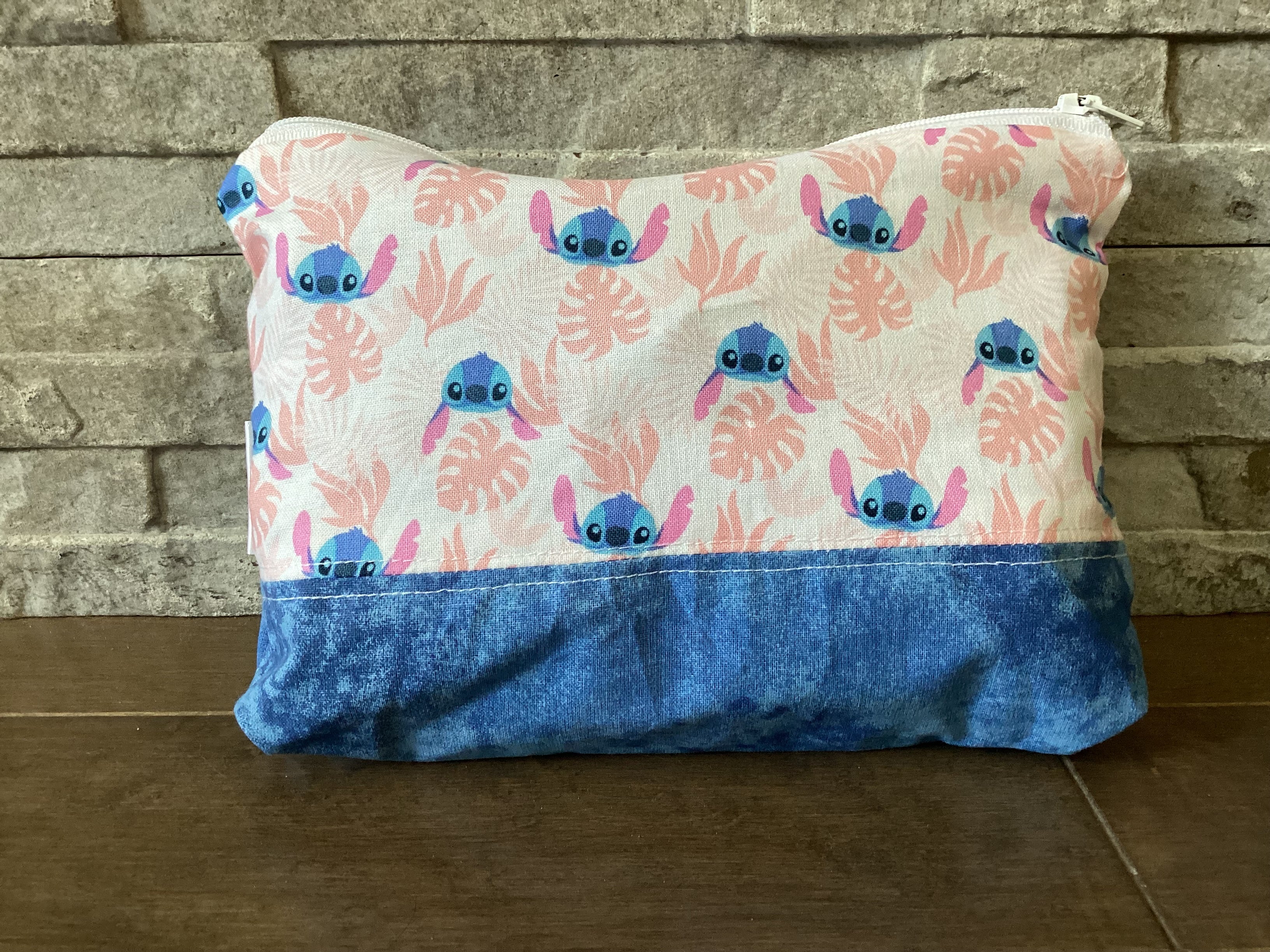 Small blue alien pouch with pink and blue background